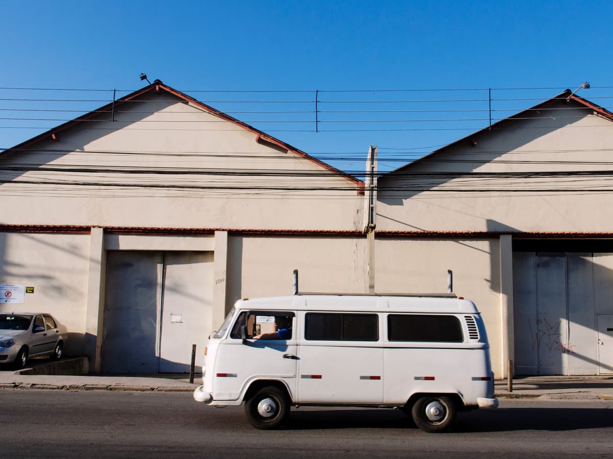 A single plumbing van parked on a Phoenix street at sunrise