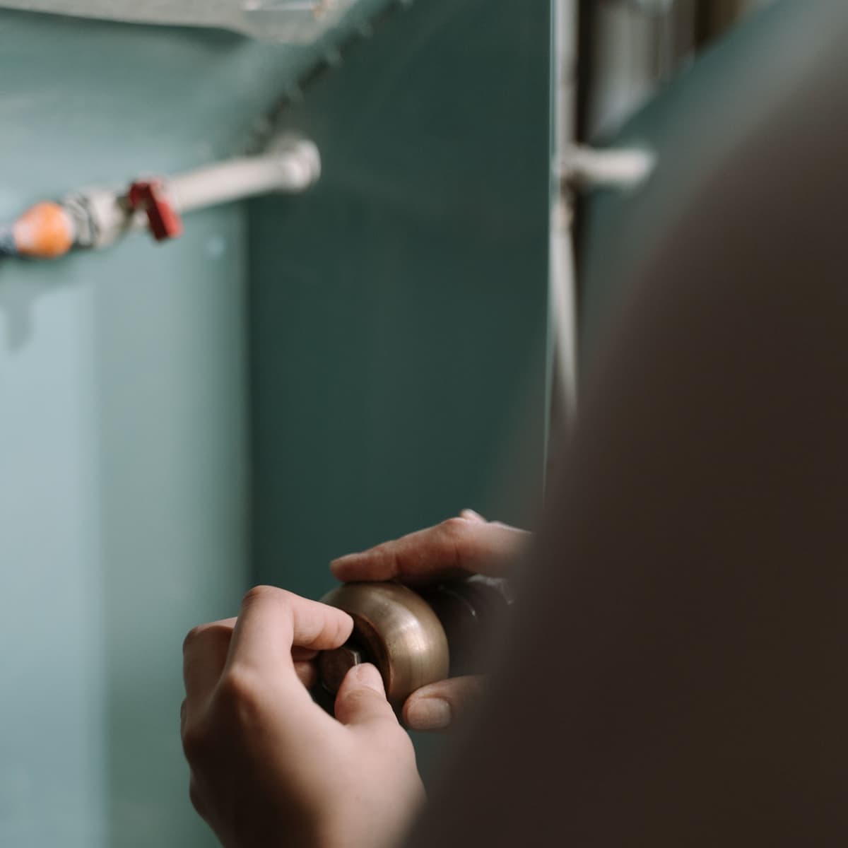 Plumber replacing a shutoff valve under a sink