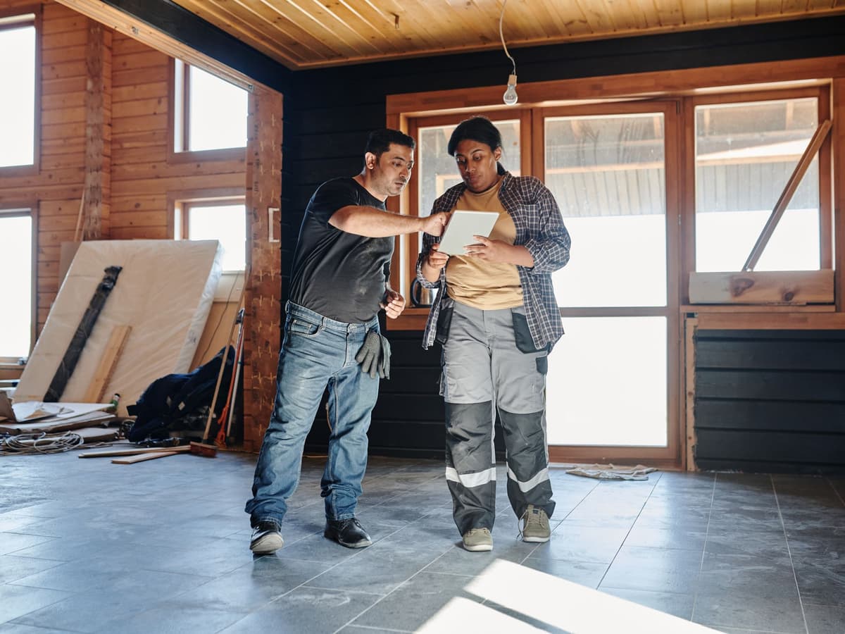 Plumber reviewing a maintenance checklist with a homeowner